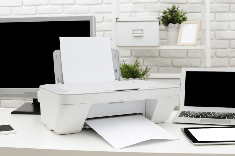 white home office printer with laptop and monitor on desk